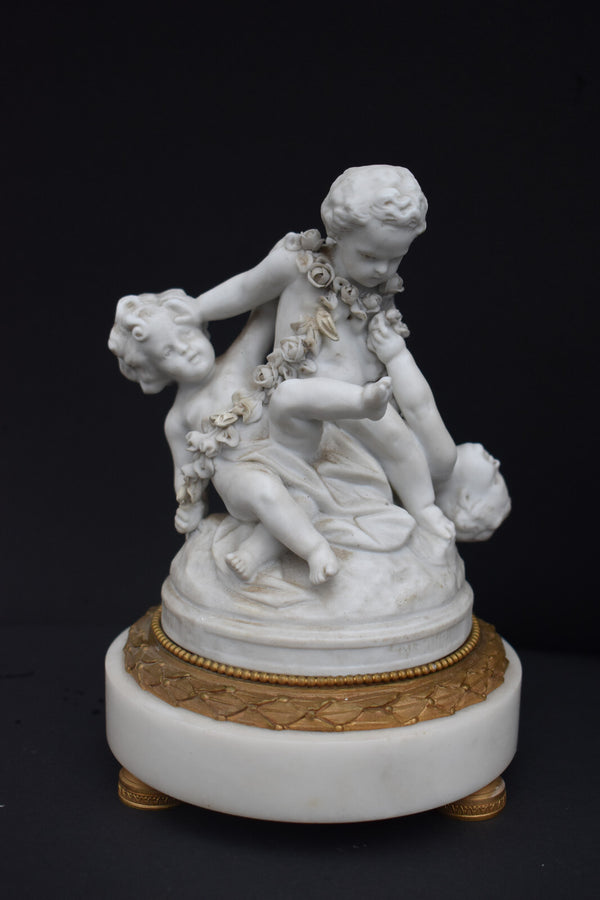 Antique bisque porcelain putti group statue playing marble base