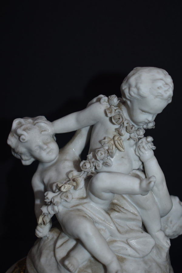 Antique bisque porcelain putti group statue playing marble base