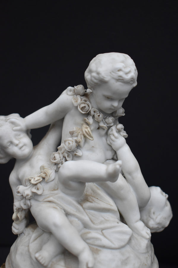 Antique bisque porcelain putti group statue playing marble base