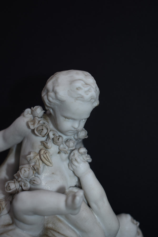 Antique bisque porcelain putti group statue playing marble base