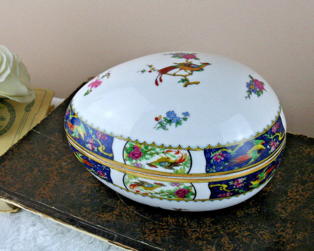 A large Easter Egg lidded box in Limoges marked porcelain with birds floral