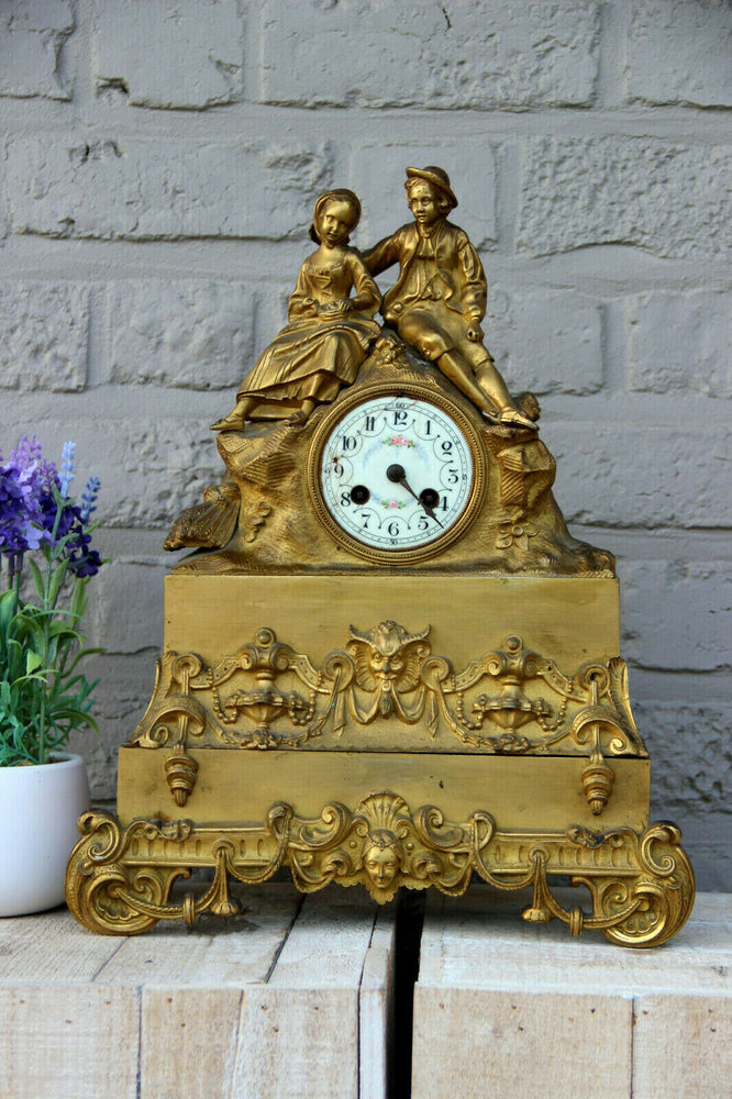 Antique french bronze gold gilt mantel clock Devil putti head couple figurines