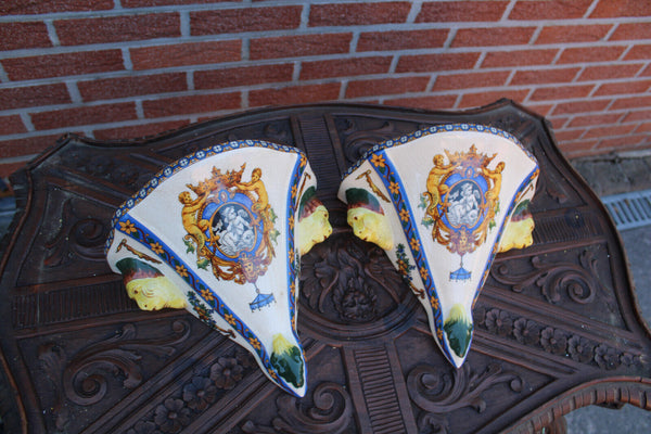 PAIR GIEN Faience mythological putti cherub scene caraytid head wall consoles