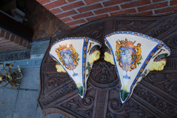 PAIR GIEN Faience mythological putti cherub scene caraytid head wall consoles