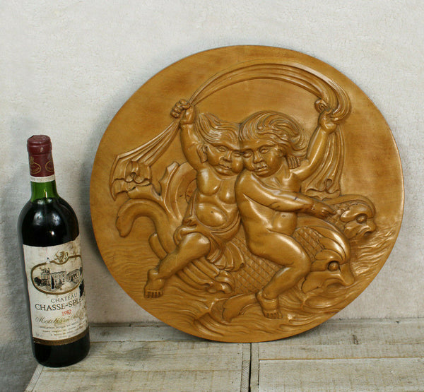 Vintage italian wood carved putti cherub dolphin riding round wall panel plaque