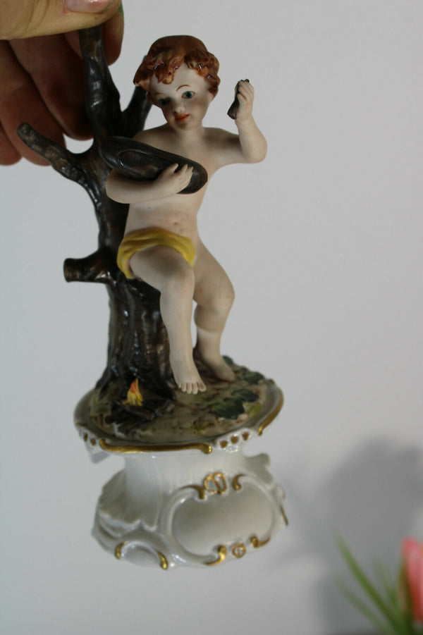 vintage capodimonte marked Figurine statue putti fire making