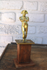 Antique brass napoleon statue on wood pedestal