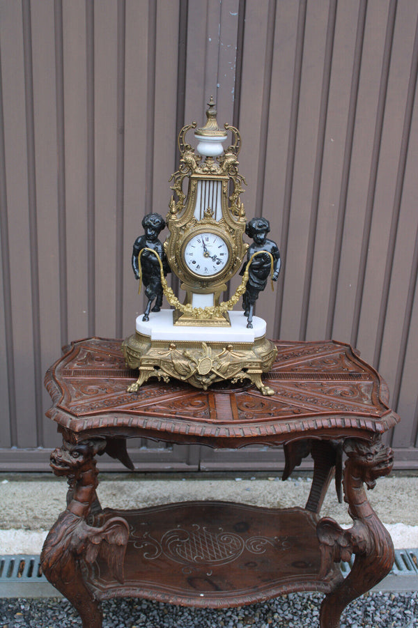 Vintage bronze marble white faun putti cherub figural mantel clock